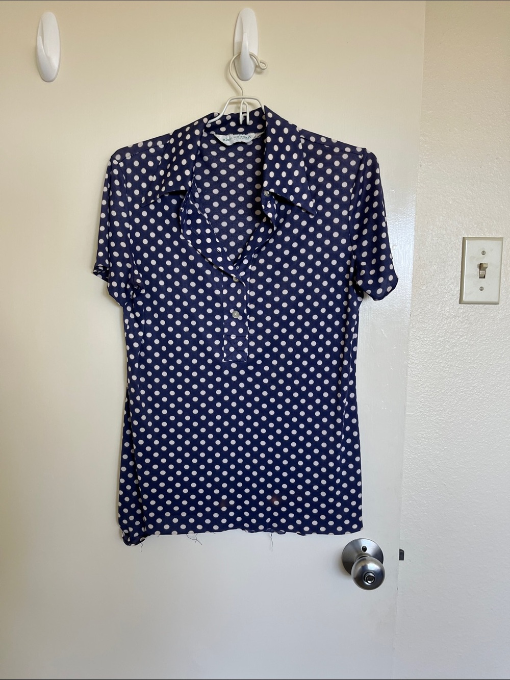 Navy with white polka dots small polyester shirt.